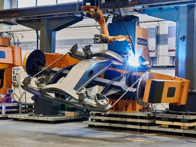 Close-up of a welding operation: sparks flying from a metal seam in an industrial hall